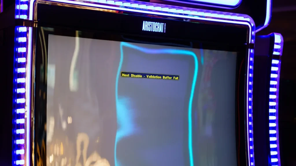 Slot machine screen showing 'Host Disable - Validation Buffer Full' error with bright blue neon borders.