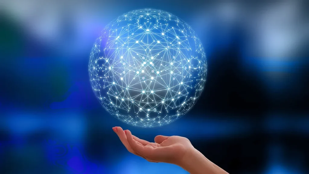 A glowing blue network sphere representing AI technology, hovering over a human hand.