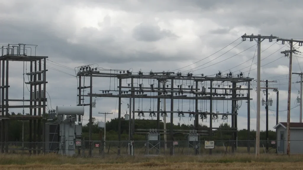 An electrical substation under a cloudy sky, representing critical energy infrastructure.