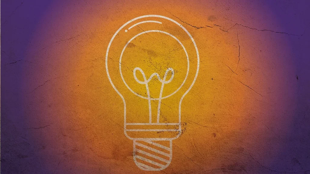 A white line-art light bulb icon centered on a textured orange and purple gradient background.