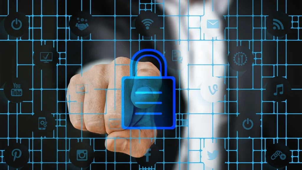A hand touches a glowing blue padlock icon on a digital grid with social media symbols, representing data security.