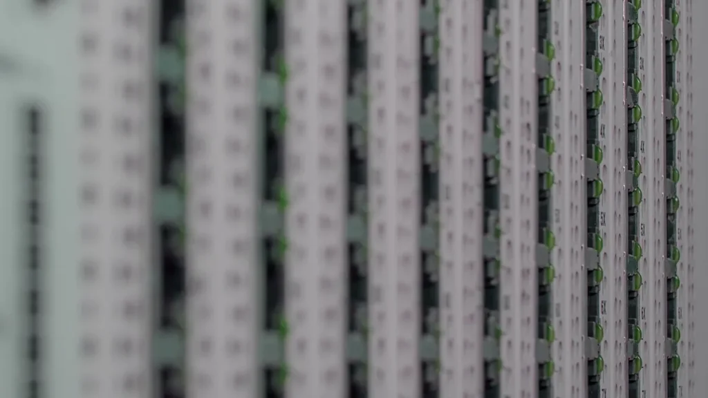 Close-up of vertical server rack columns with green indicator lights and numeric labels in a data center.