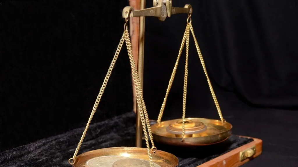 Brass balance scale with coins, symbolizing the weighing of tokens and resource consumption.
