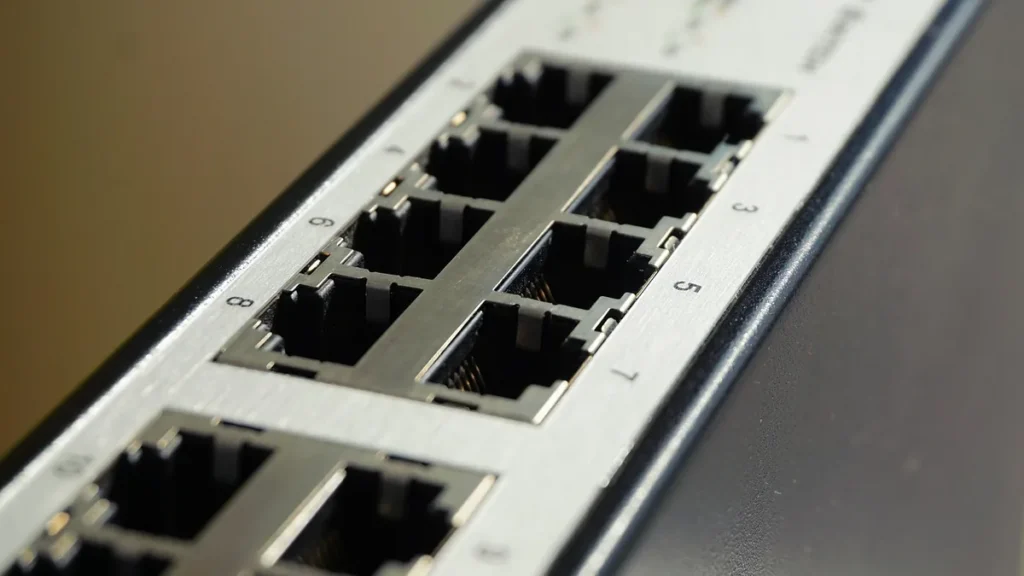 Close-up of a silver network switch showing multiple numbered Ethernet ports.