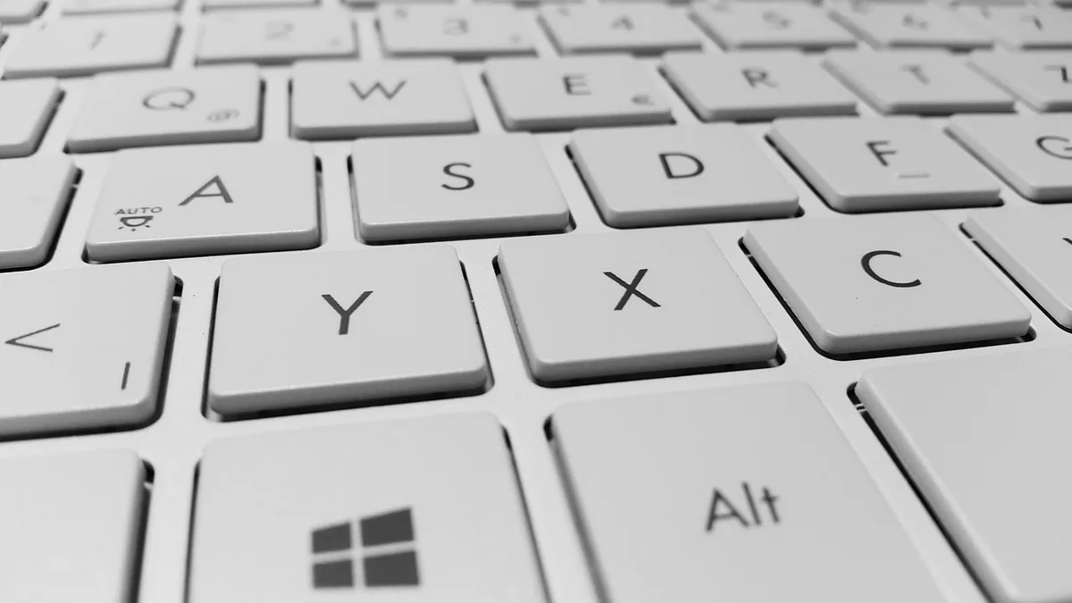Close-up of a clean white chiclet keyboard focusing on the Y, X, C, and Windows logo keys.