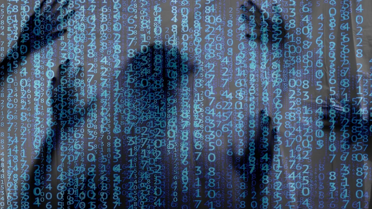 Silhouetted figures behind a screen of cascading blue numbers, symbolizing digital data confinement and cyber surveillance.