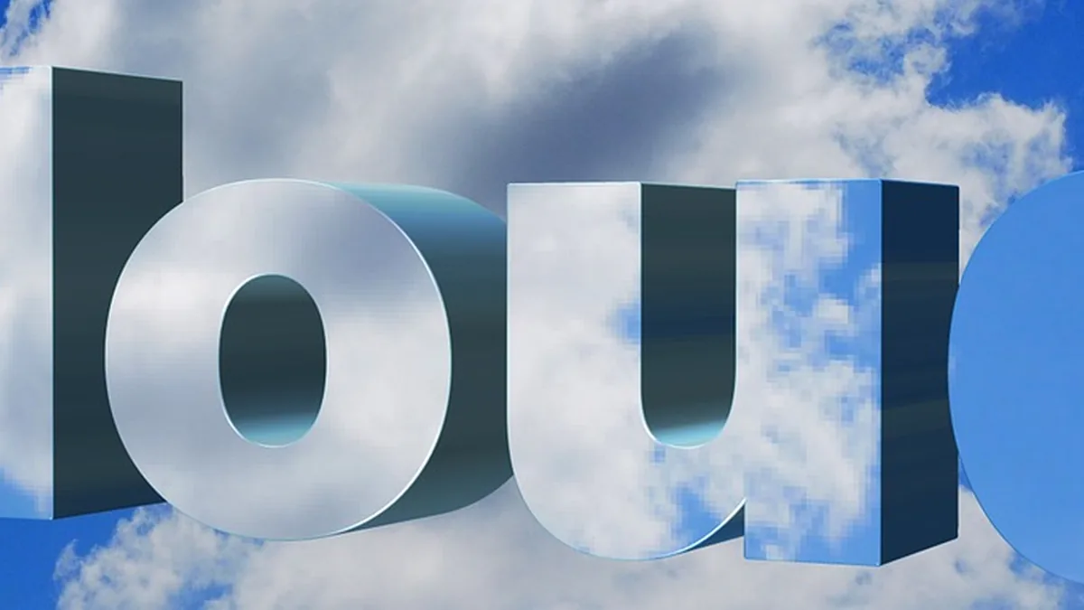 Cropped view of giant silver 3D letters spelling 'cloud' reflecting a cloudy blue sky.