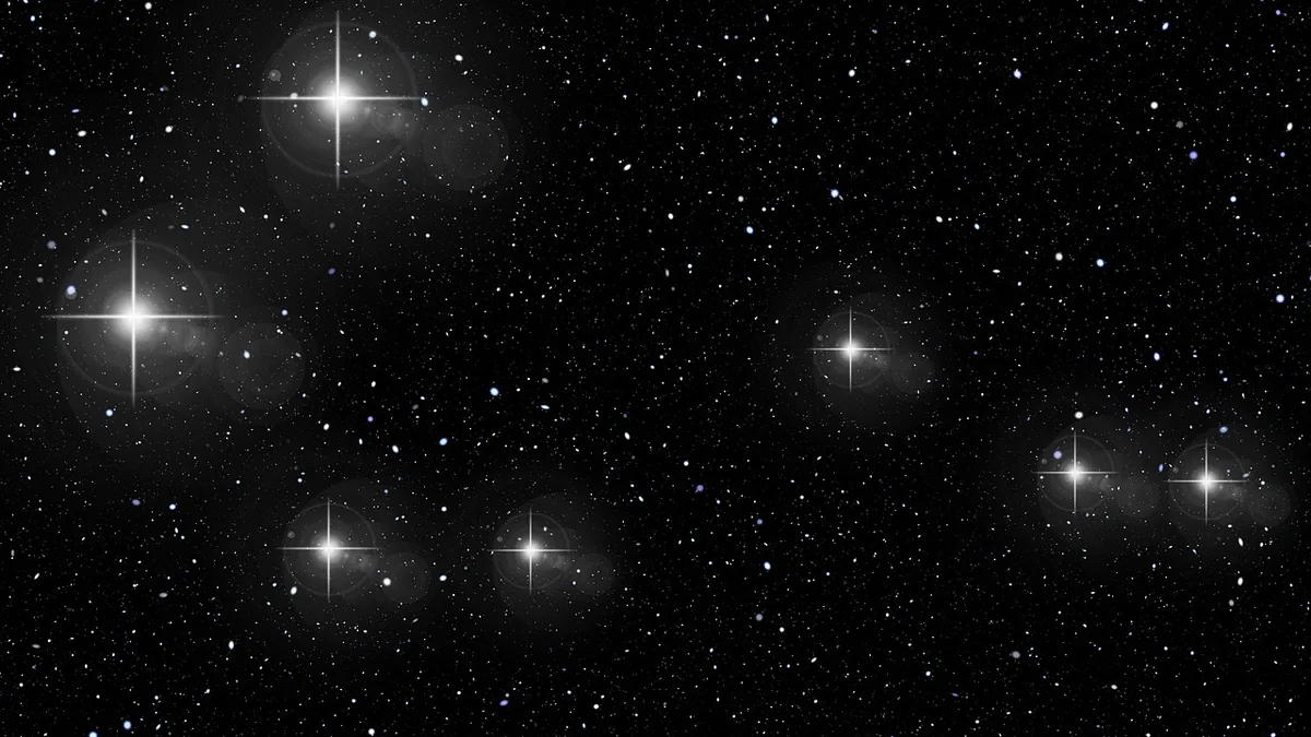 Bright stars with cross-shaped lens flares sparkle against a dark, star-filled space background.
