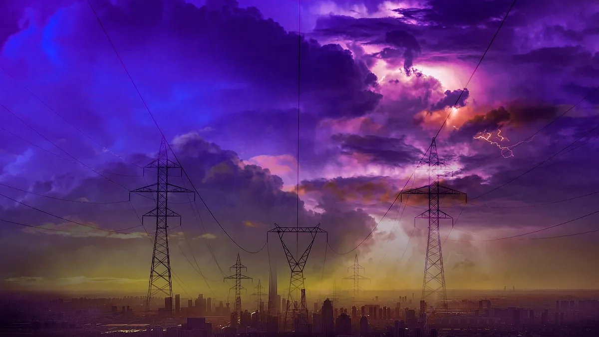 Silhouetted power lines and pylons stand against a dramatic purple stormy sky with lightning over a city skyline.