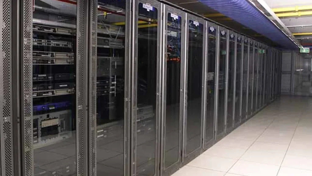 A long row of server racks with glass doors inside a clean, well-lit data center server room.