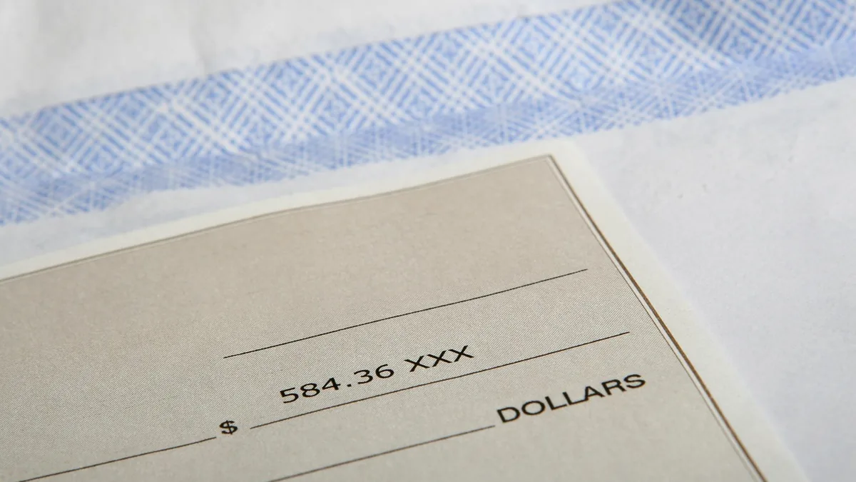 Close-up of a check showing a dollar amount, symbolizing payroll and financial transactions.