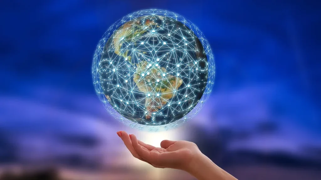 A glowing, network-covered globe hovers over an open hand against a deep blue twilight sky, symbolizing global digital