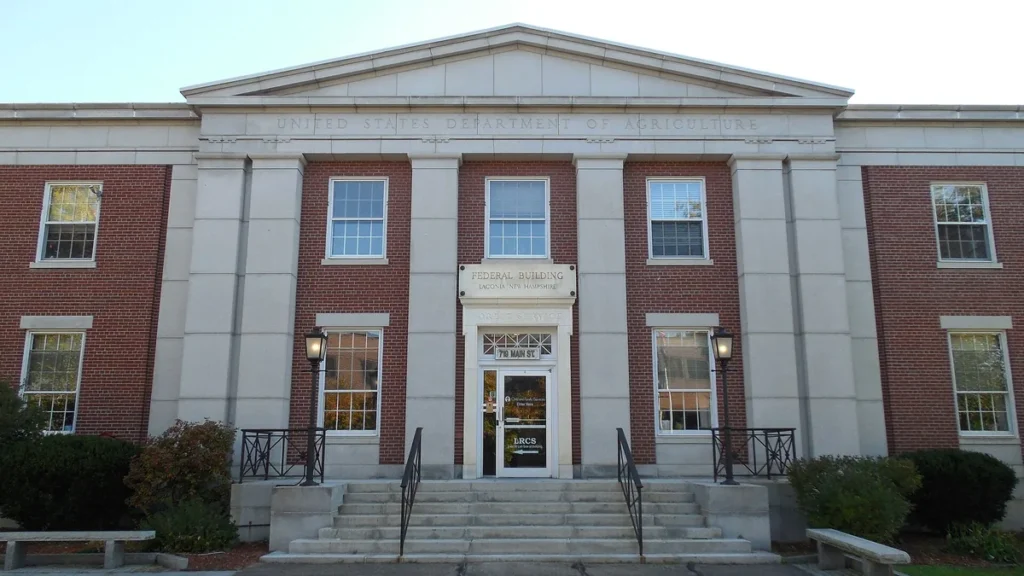 The USDA Federal Building in Laconia, New Hampshire, showing brick facade, columns, and steps.