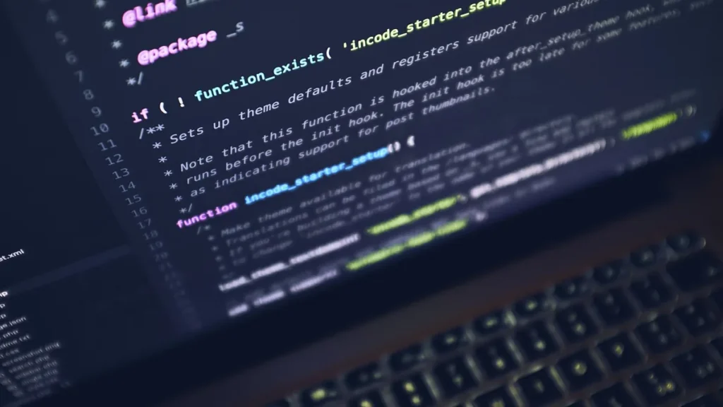 Close-up of PHP code on a laptop screen with keyboard in foreground.