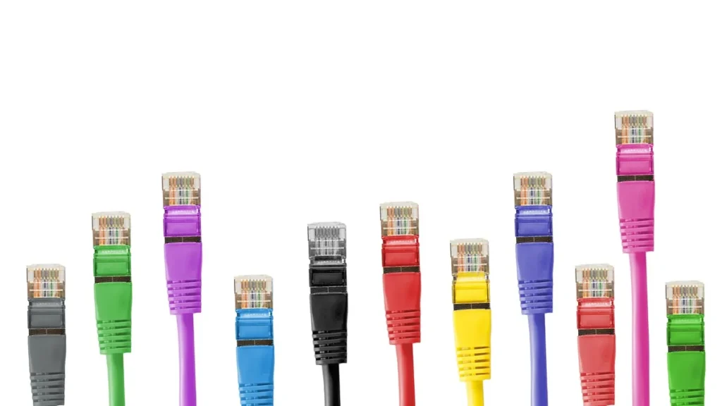 Multi-colored ethernet network cables aligned vertically on a clean white background.
