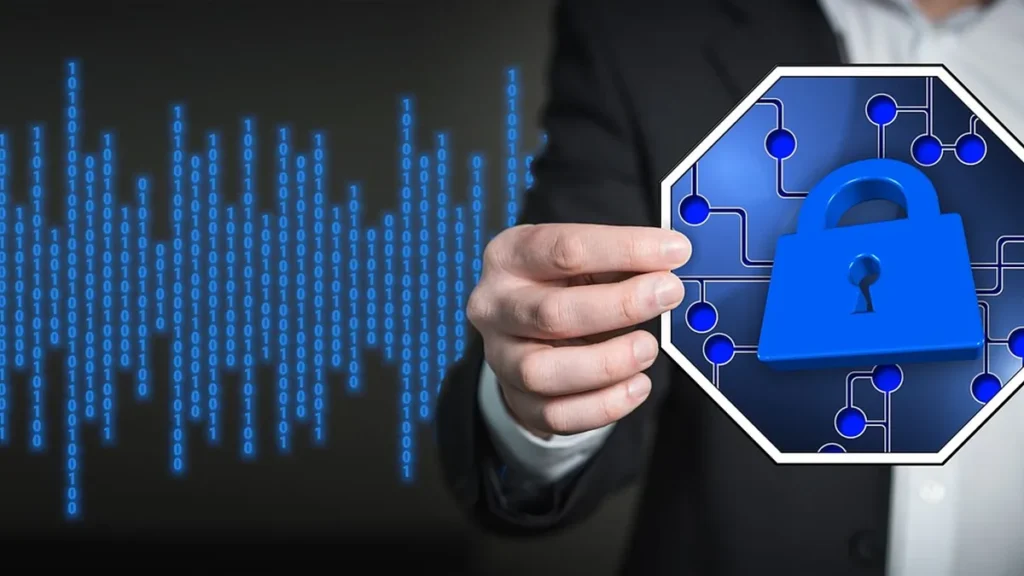 Hand holding a blue padlock icon on a circuit board, with binary code background.