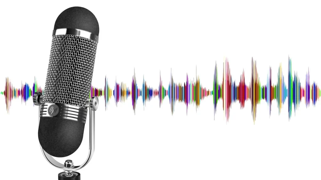 A vintage-style microphone stands against a colorful, vibrant audio soundwave on a clean white background.