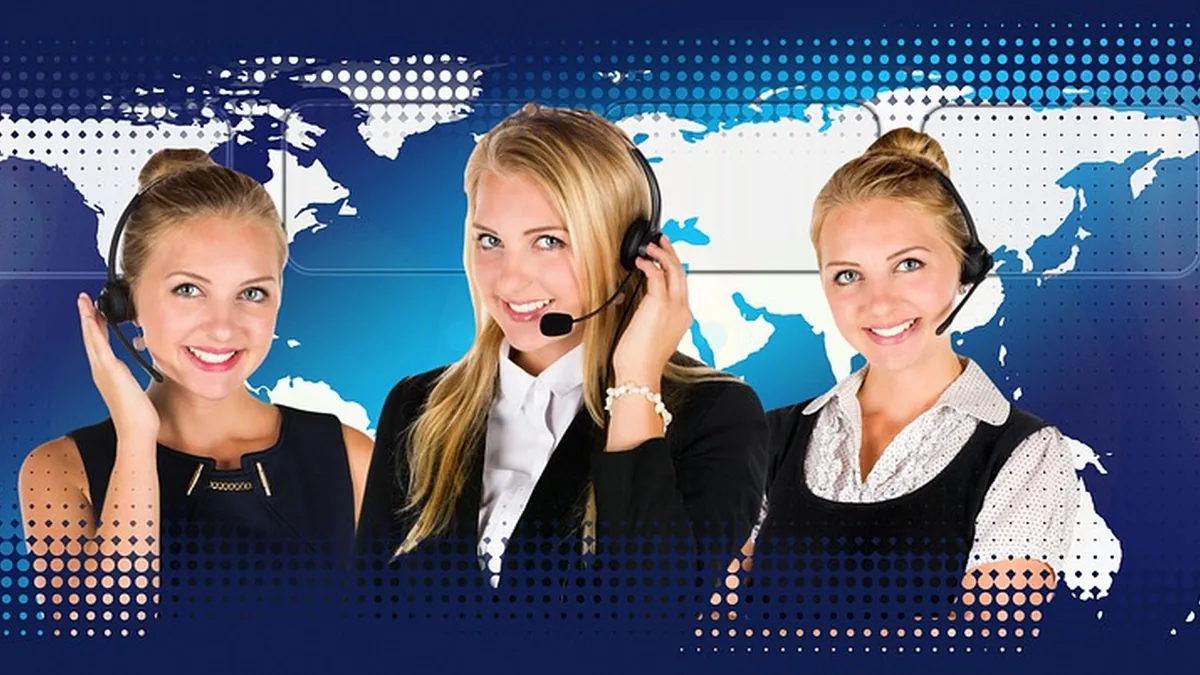 Three smiling blonde women wearing headsets against a blue background with a world map, representing global customer service