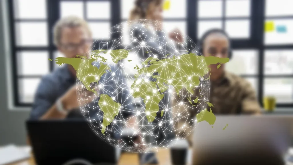 A glowing green network globe visualizes global cyber connectivity over a blurred office background.